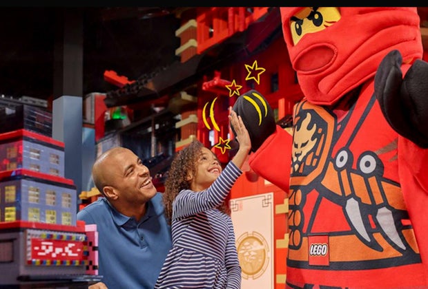 Image of a family seeing a life-size Lego character.