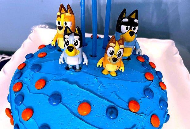 You can make a Bluey cake at home with blue frosting and toys!