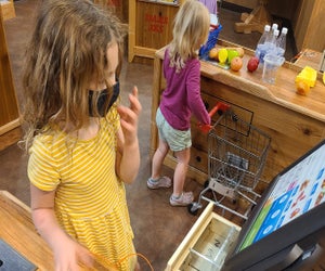 Pretend City cashier duty. Photo by Matt Matasci