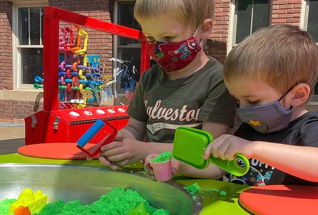 Photo of kids playing on patio of NH Children's Museum.