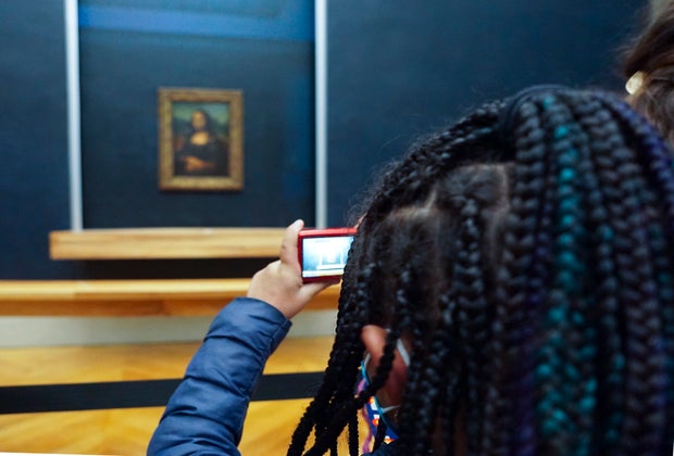 Stop and visit the Mona Lisa at The Louvre Museum in Paris with Kids