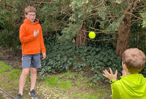 Hiking Games for Kids That Turn Walks into Adventures: kids playing catch with a tennis ball