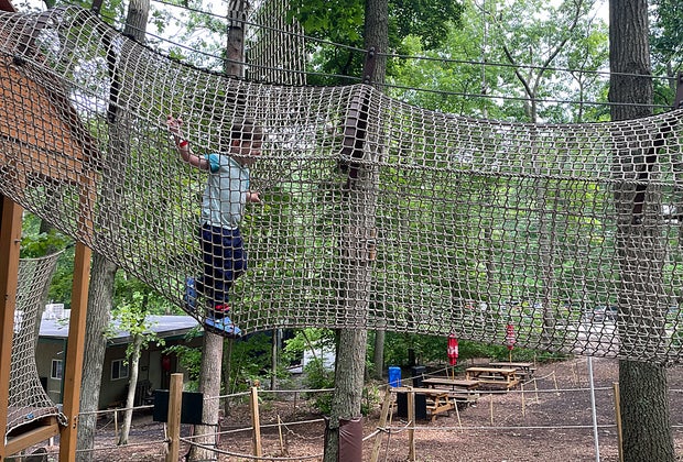 Little boy in a rope bridge at The Adventure Playground