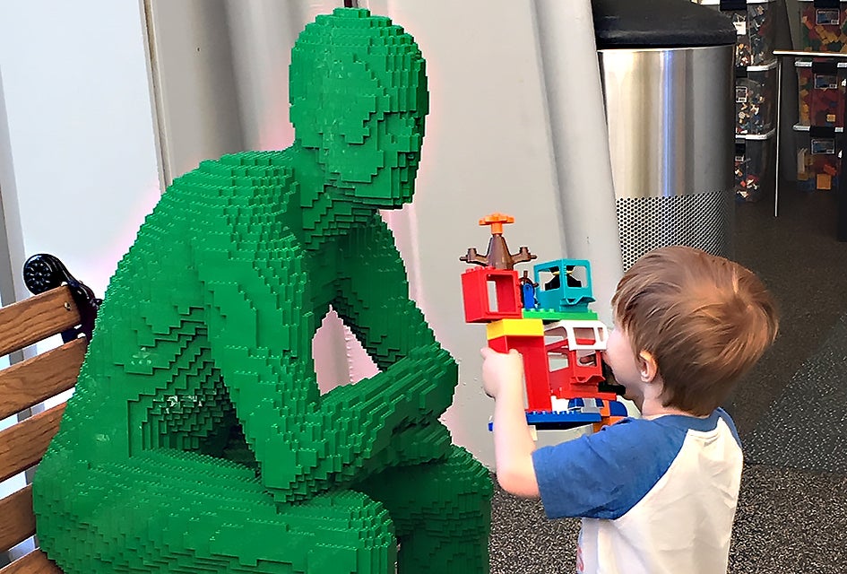 Green and blue brick men preside over the play stations at The Art of the Brick.