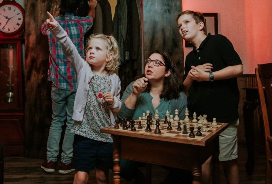 Participants work together to solve puzzles and escape a themed room before time runs out at Breakout Games. Photo by Faith Neece