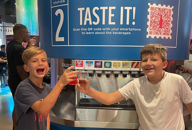 boys cheering to tasting coca cola products at Taste it!