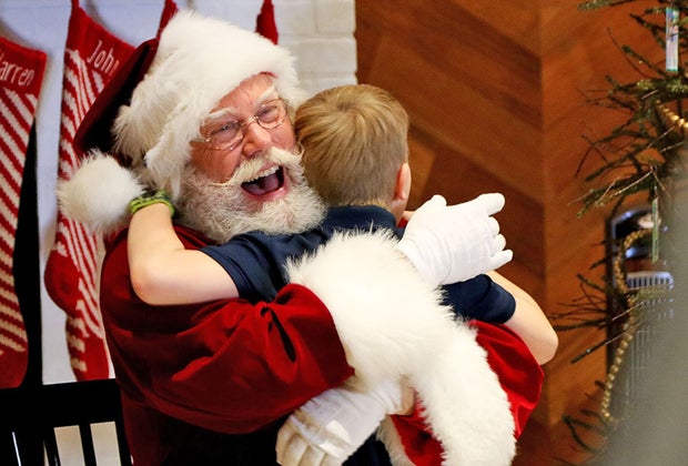 Boy getting a hug from Santa