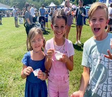 Families sample tons of ice cream flavors, all for a great cause! Visitors to the 20th Annual Miss Mary's Ice Cream Crankin' are treated to locally churned ice cream flavors plus some fun giveaways.  Photo by the author