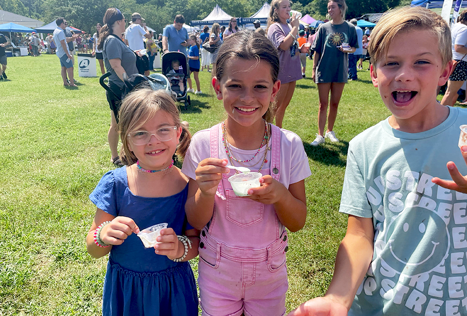 Families sample tons of ice cream flavors, all for a great cause! Visitors to the 20th Annual Miss Mary's Ice Cream Crankin' are treated to locally churned ice cream flavors plus some fun giveaways.  Photo by the author