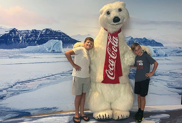 boys posing with the famous Coke Polar Bear