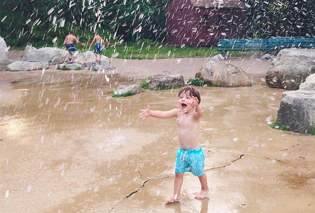 Image of child splashing in sprinkler park-Best splash pads and splash park