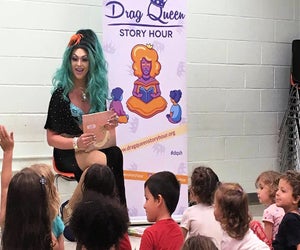 Mermaid Queen Bella Noche reads at the library. Photo courtesy of Drag Queen Story Hour