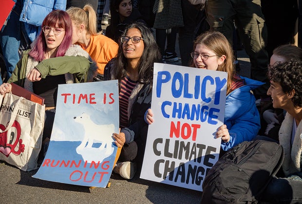 Climate Change Anxiety in Kids photo of teens sitting in at a protest