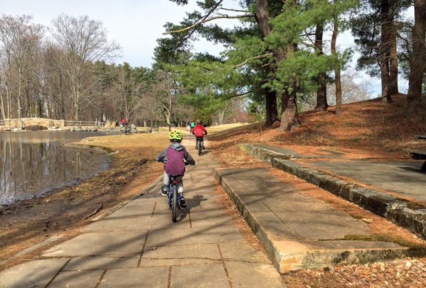 Photo of kids biking along the edge of a pond - stroller-friendly hikes