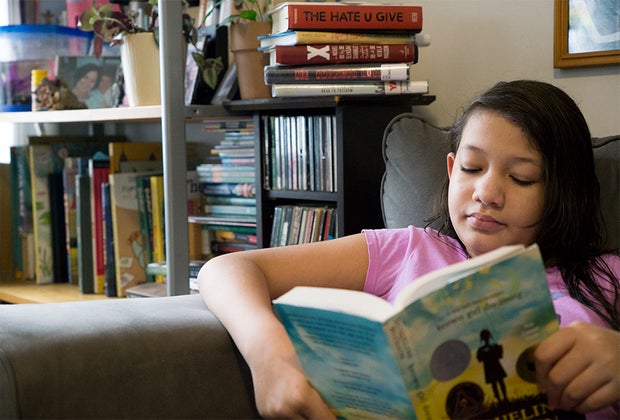 GIrl reading in chair Brown Girl Dreaming Black history for children