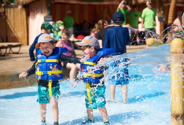 Photo of two kids getting splashed with water- Best Outdoor Water Parks