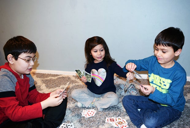 A picture of kids playing go fish, one of the best card games for kids of all ages