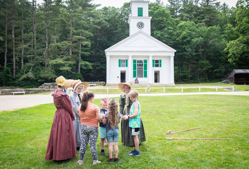Take the young ones to Old Sturbridge Village to encounter history. Children Playing Games with Costumed Historians on the Common. Photo courtesy of Old Sturbridge Village