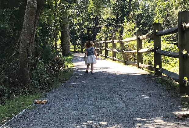 girl on path at path woods in zoo