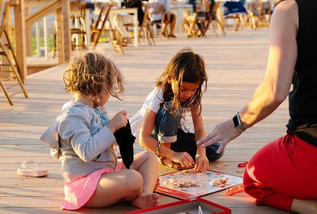 Kids playing scrabble at Collective Givernors Island
