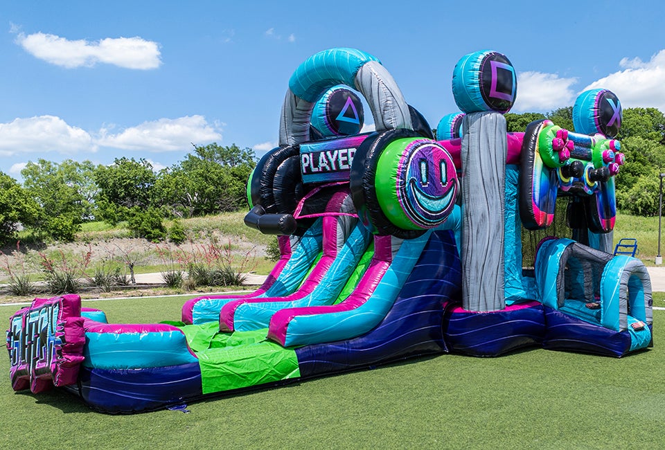Orlando Fun Bounce's Glitch Gamer is a vibrant inflatable bounce house and slide combo, with gamer-inspired graphics and high-energy design. Photo courtesy Orlando Fun Bounce