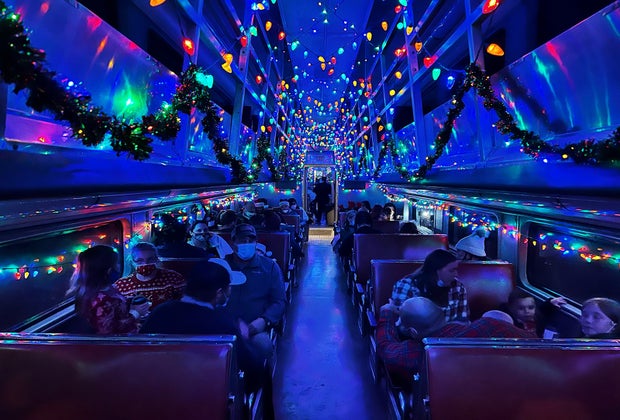 Guests take their seats aboard vintage train cars for The Polar Express ride.