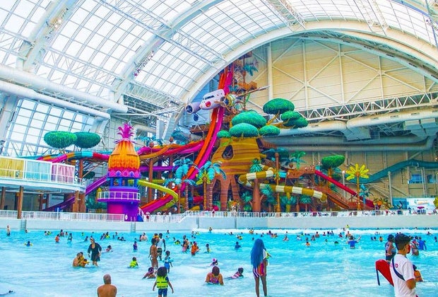 wide shot of zero-entry people at indoor water park