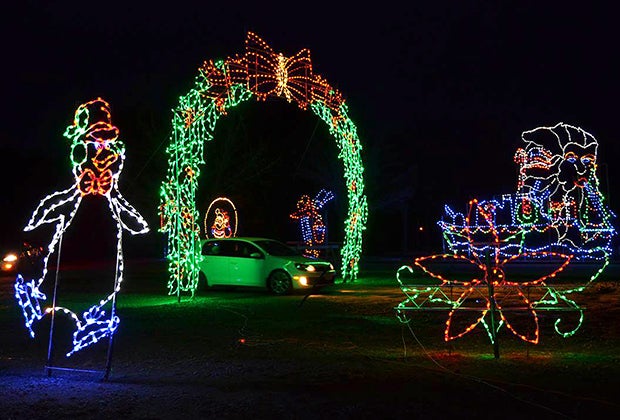 Cars drive past and through illuminated displays at the Skylands Stadium Christmas Light Show