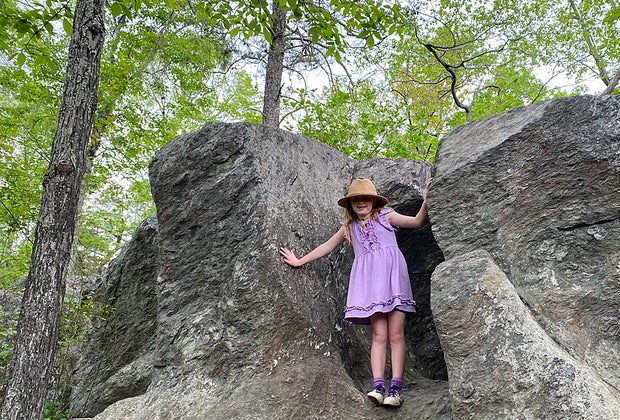 Fall foliage hikes in the Delaware Water Gap: Little girl climbing a rock