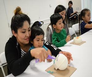 Fiesta Matsuri participants enjoying a skull candy decorating workshop. Photo by Scott Oshima