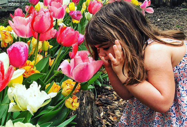 Image of girl with flowers - Things To Do on Mother's Day 2024