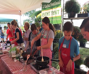 Local children and teens compete in Junior Garlic Iron Chef to create a master garlic-flavored pasta sauce - in front of a live audience - in only half an hour at the Garlic Festival at the Garden Of Eve. Photo courtesy of the farm