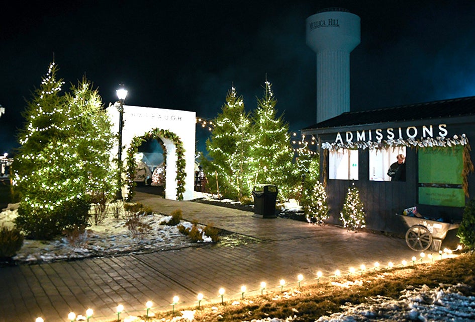 Twinkling lights greet visitors to Harbaugh Village, which focuses on family fun and giving back.