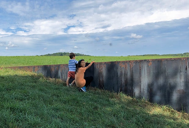 Hudson Valley fall family getaway: Two kids peering over a wall at Storm King Art Center