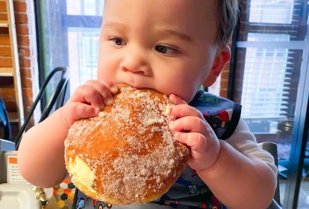Image of child eating pastry - Cheap Places to Eat in Boston