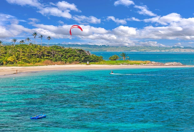 Kite surfer catching air on St. Lucia's beautiful Caribbean beaches.