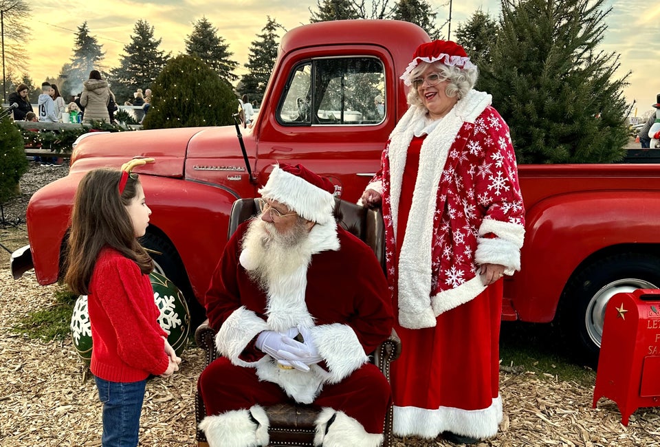 Mr. and Mrs. Claus have a great photo-op with a little red truck at Santa's Christmas Tree Farm in Cutchogue. Photo by Jennifer Voit