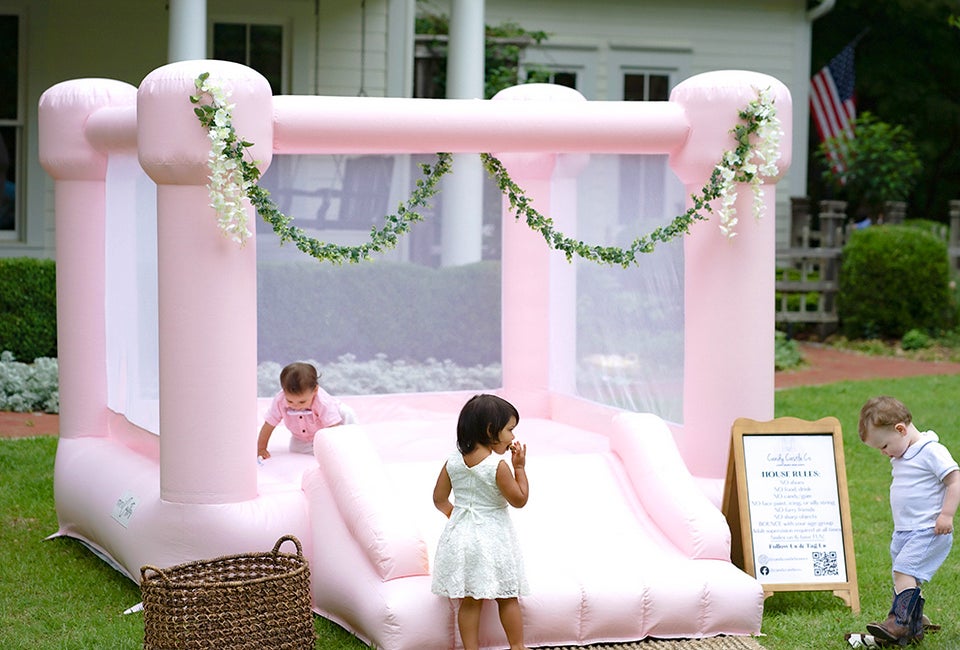 Add a charming bounce house, like this one from Candy Castle Co., to enhance your child's next birthday party. Photo by Wilson Creative Co. Photography, courtesy of Candy Castle Co.