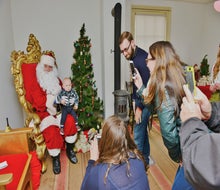 Sit on Santa's lap at Historic Richmond Town, which transforms into an old-time Dickens Village for the holidays. Photo courtesy of Historic Richmond Town