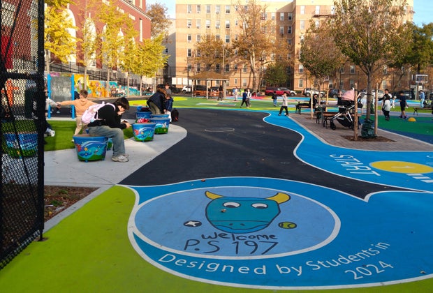 PS 197 playground renovation: Overview of a colorful playground with children's drawings