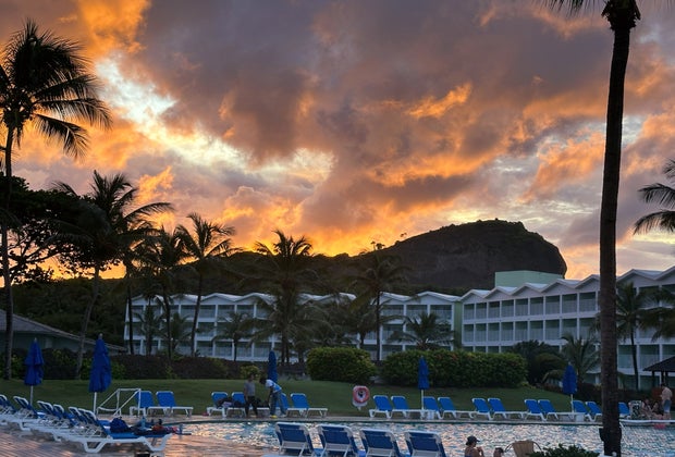 Sunset over a hill behind a hotel on the beach in St. Lucia.