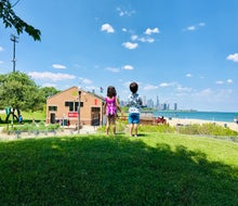 Two little Chicagoans, fresh from the splash pad at 31st Street Harbor, contemplate going to the beach. 
