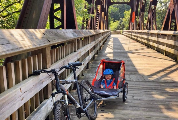 Image of child in bicycle carrier on CT hiking trail.
