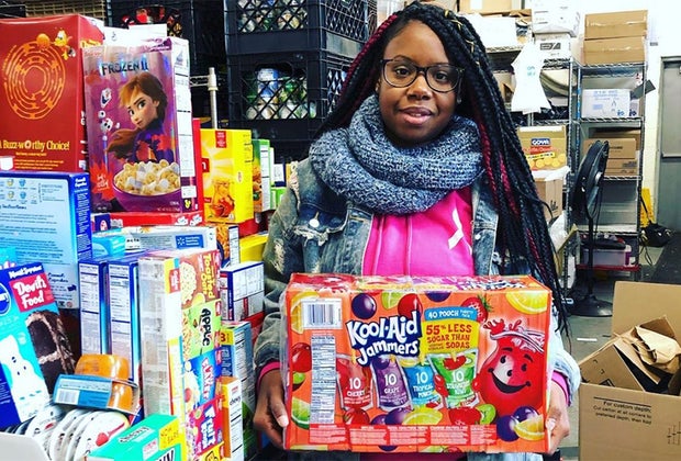 Girl poses with donated items at The INN