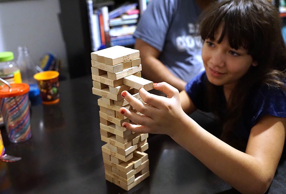 Pull out a block, place it on top but don't let the tower fall in the fun and challenging Jenga.  Photo by Jody Mercier