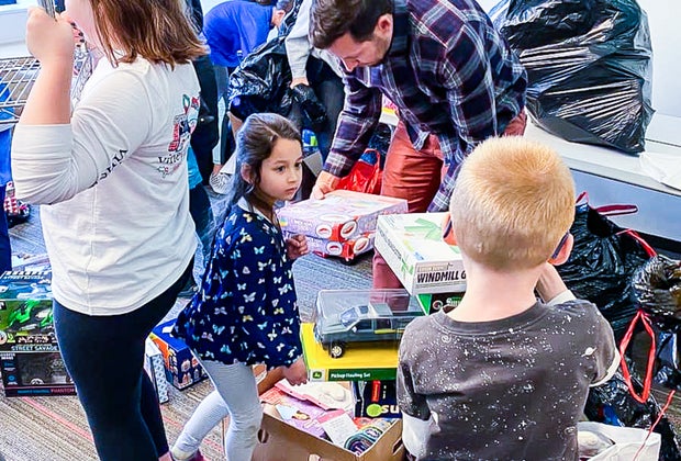 Members of the Kids Advisory Council organize toy donations.
