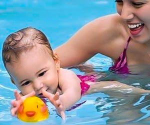 Baby swim classes are all about having fun and getting comfortable in the water. Photo courtesy of KIDS FIRST Swim Schools