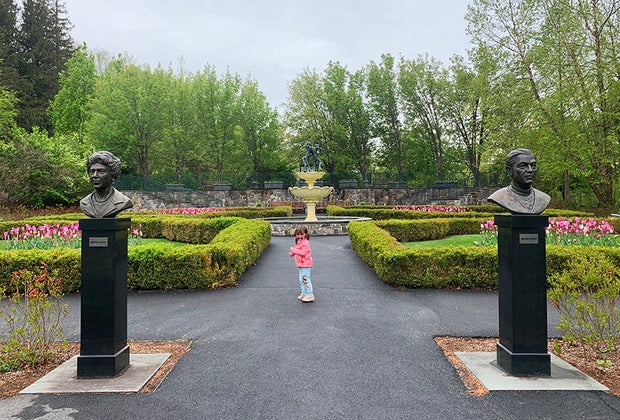 Little girl in landscaped garden at Lasdon Park & Arboretum