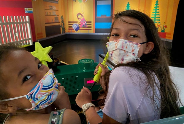 Girls with wands on Legoland Discovery Center's Imagination Express