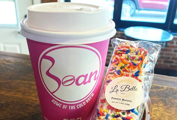 a cup of to-go coffee and a sweet treat at Babylon Bean Coffee House.